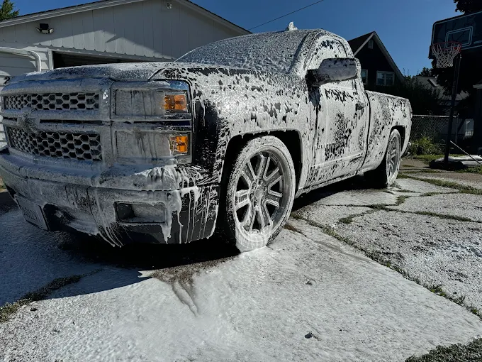 Chevy Silverado covered in white foam during detailing