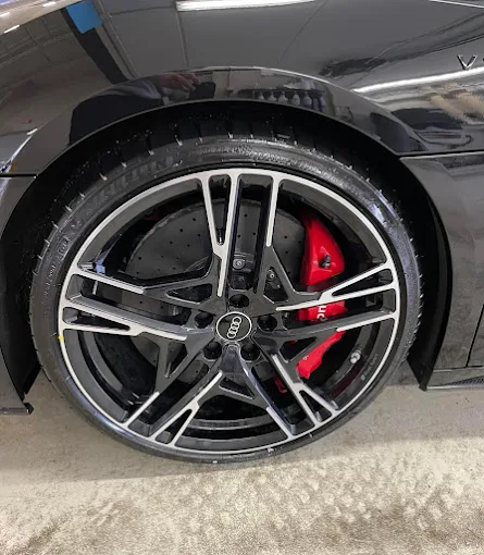 Audi wheel with red brake caliper after detailing