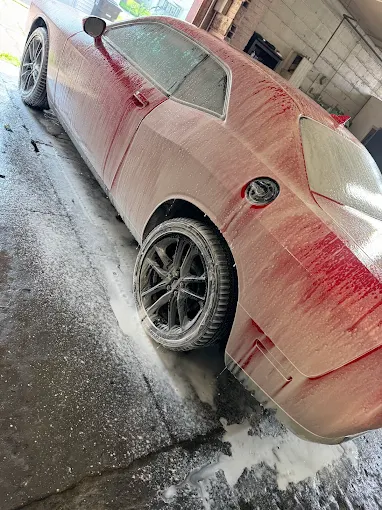 Car covered in foam during detailing process